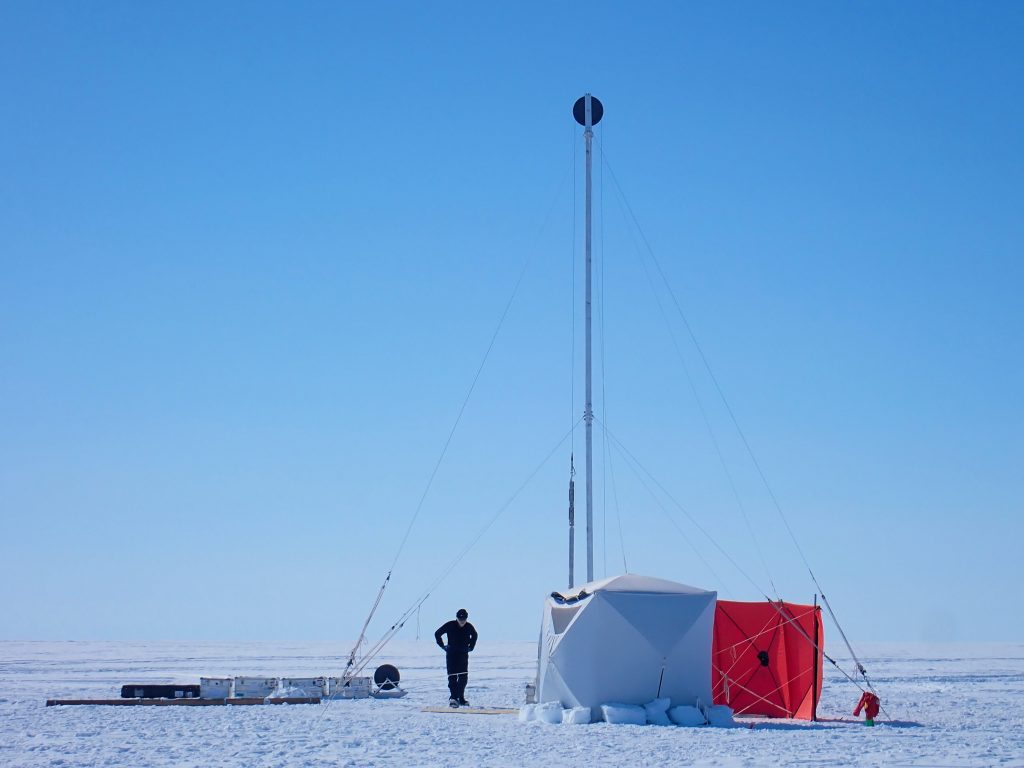 A photo of the Sherman Island drill site set-up, with mast, anchors, and shelters all in place.